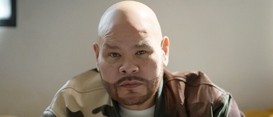 Fat Joe, a bald man with a medium-pale skin tone, looking directly at the camera